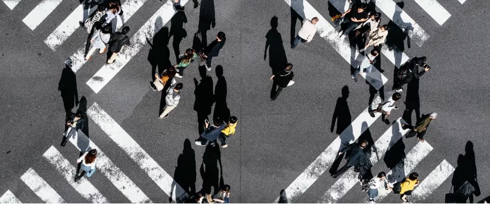 a group of people walking on a street