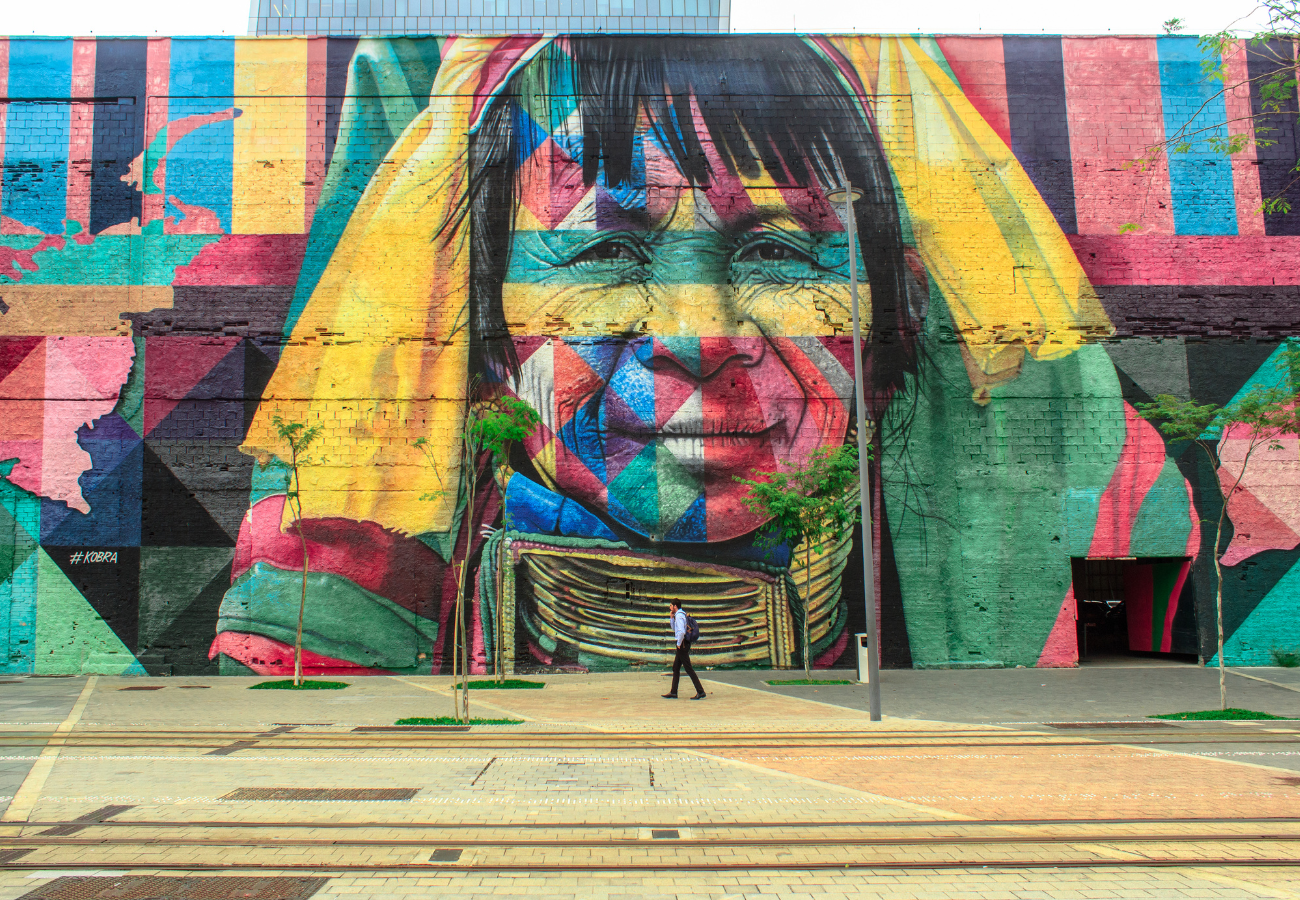 Photo from mural depicting a calm, wise, multicoloured face, representing an Indigenous nation and emotional wellbeing.