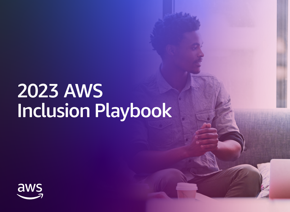 a man and woman sitting and conversing, a laptop open in front of them on the table - 2023 AWS Inclusion Playbook