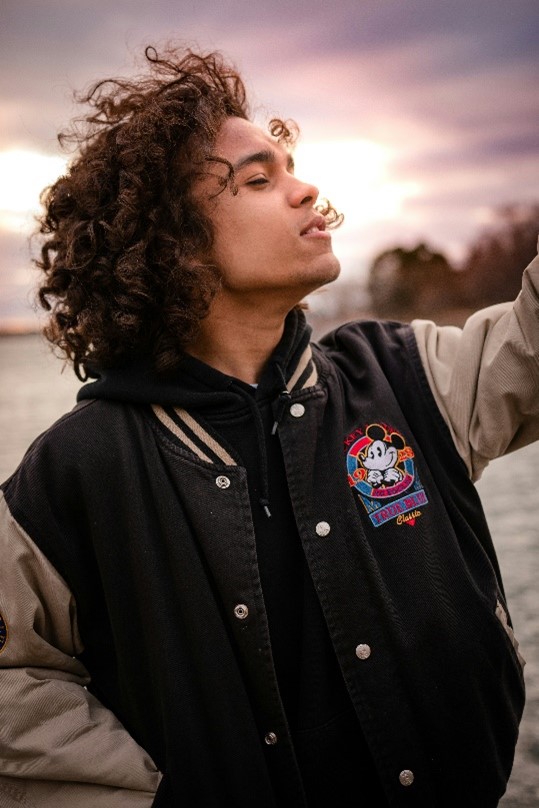 Young man who could be racialized 'black' with light brown skin